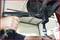 A person is using a pneumatic tool to tighten a screwdriver on an automotive part fastening; focus on the tool and hand.