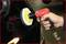 A person is polishing the paintwork of a car with a red and yellow polishing machine to smooth and shine the surface.