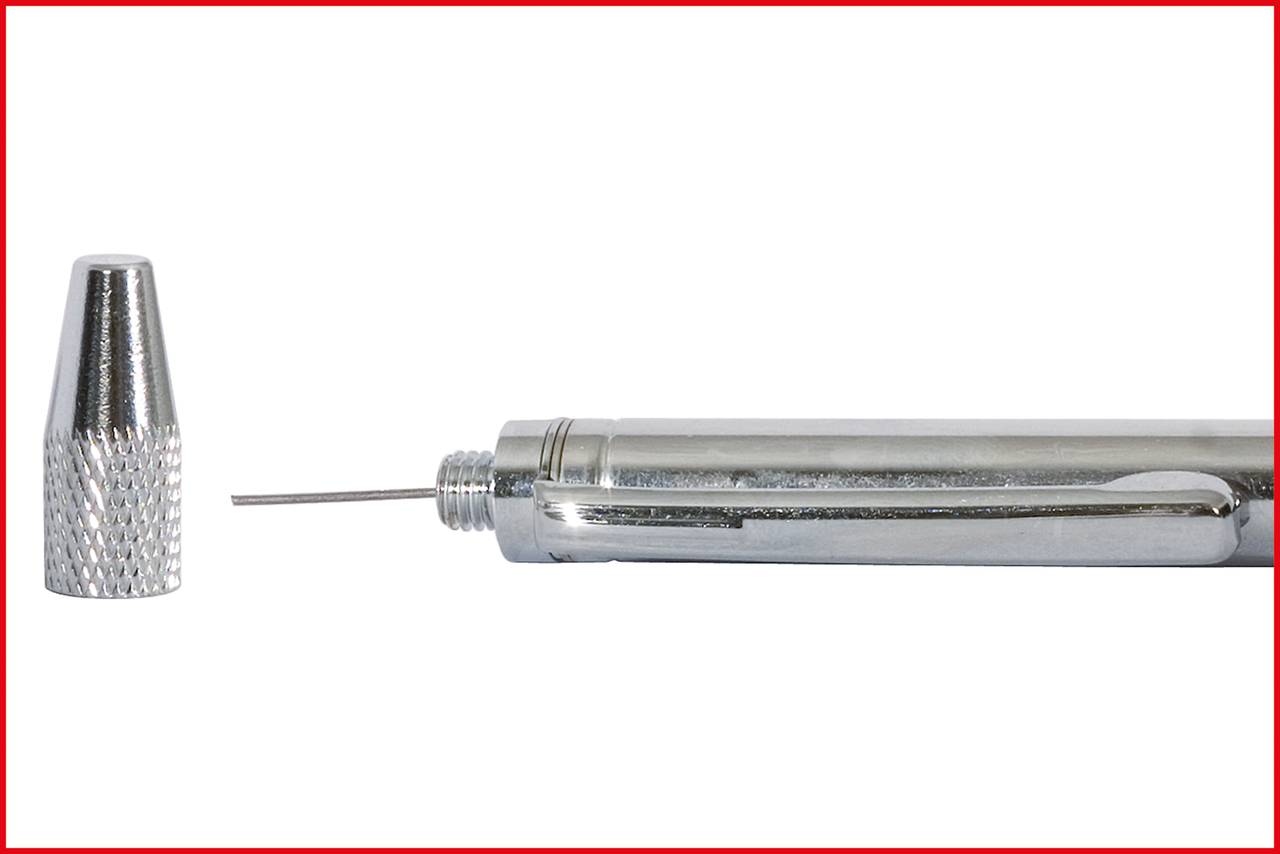 A silver-coloured precision pen with a fine needle at its tip. The cap lies beside it. The pen has a clip.