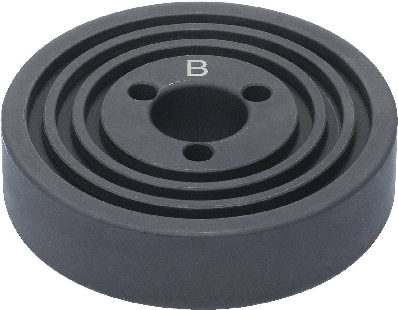 A black, round metal disc with several concentric circles and a central hole, marked with a 'B' on the surface.