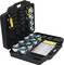 An opened black toolbox with several metallic attachments and a manual inside, arranged in compartments.