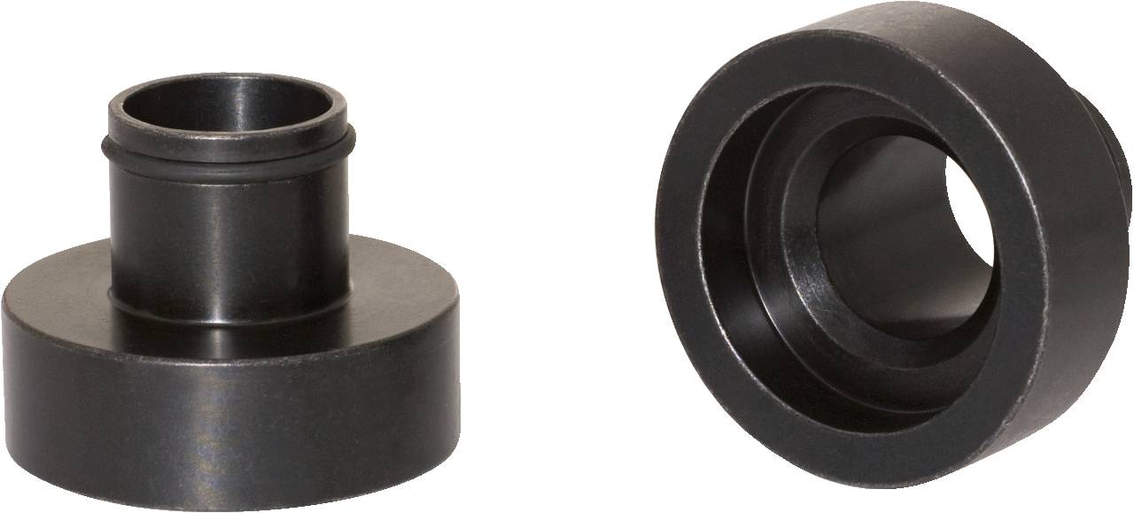 Two black metal flanges with cylindrical openings, lying side by side, show the front and rear views of the parts.