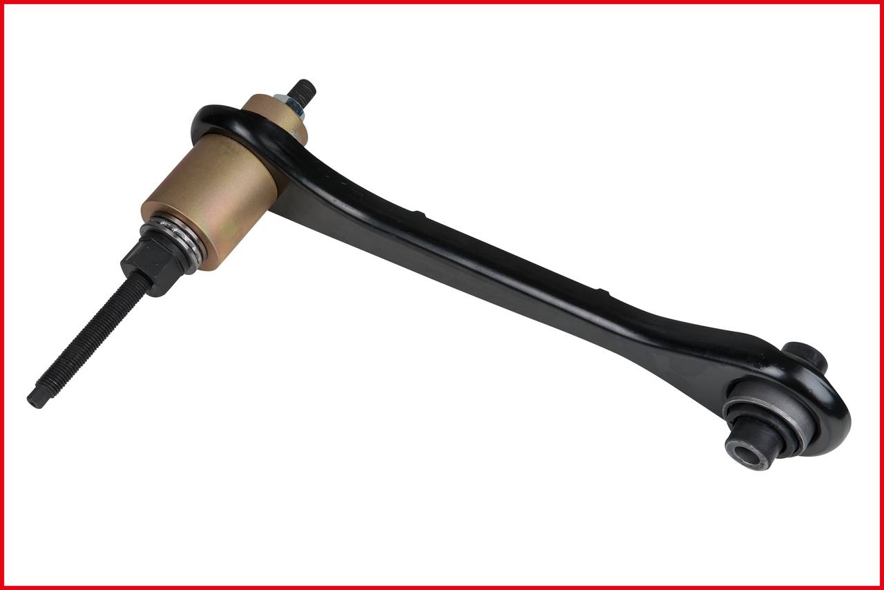 Black transverse control arm with metal bolt and rubber bushings, on a white background. Vehicle part used to connect wheel suspension and vehicle chassis.