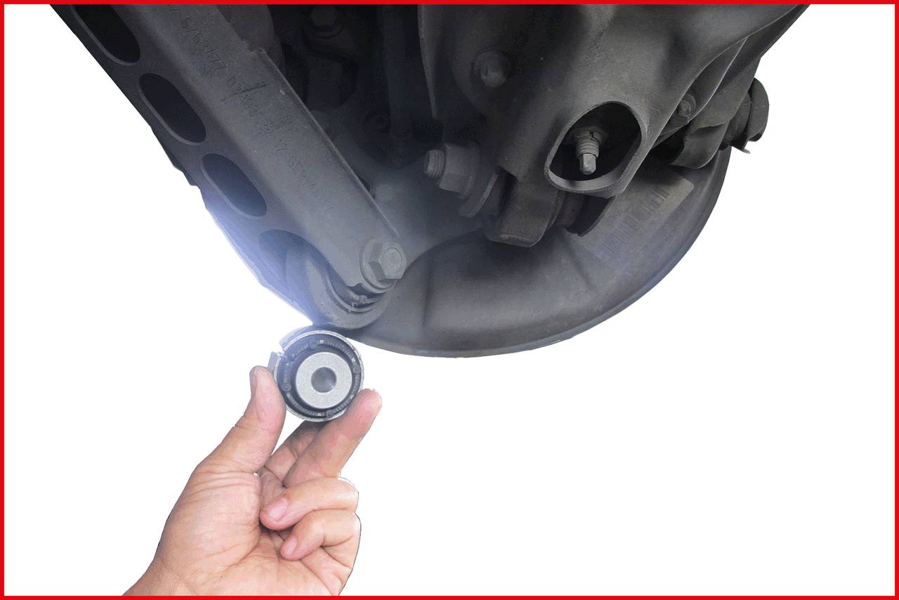 A hand is holding a round machine part beneath a larger mechanical component. It appears to be an exchange or replacement process.