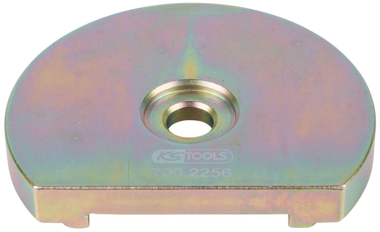 A metallic tool piece with a circular shape and a central hole. The surface shimmers with rainbow colours.