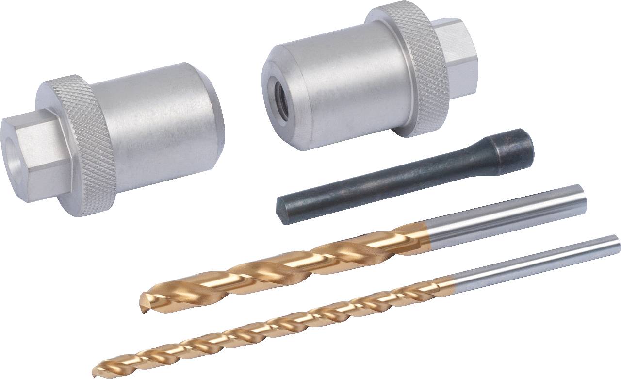 Two silver adapters, a black tool and two golden drill bits are lying side by side on a white surface.