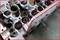 Cylinder head of an engine secured with a special tool for removing valve stem seals.