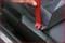 'Guidance for Belt Routing' shows a hand using a red strap on a car seat to position the safety belt more efficiently.