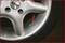 Car tyre with a silver alloy wheel, slightly damaged at the edge. The word 'EXIP' is embossed on the wheel.