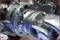 Close-up of a shiny mechanical component with screws and joints, possibly part of an engine or a machine.