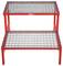 Two-stage, red metal step ladder with sturdy grid steps, suitable for use in workshops or industrial environments.
