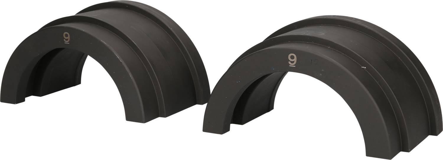 Two identical, curved structures made of dark material positioned side by side. They have a solid, industrial aesthetic.