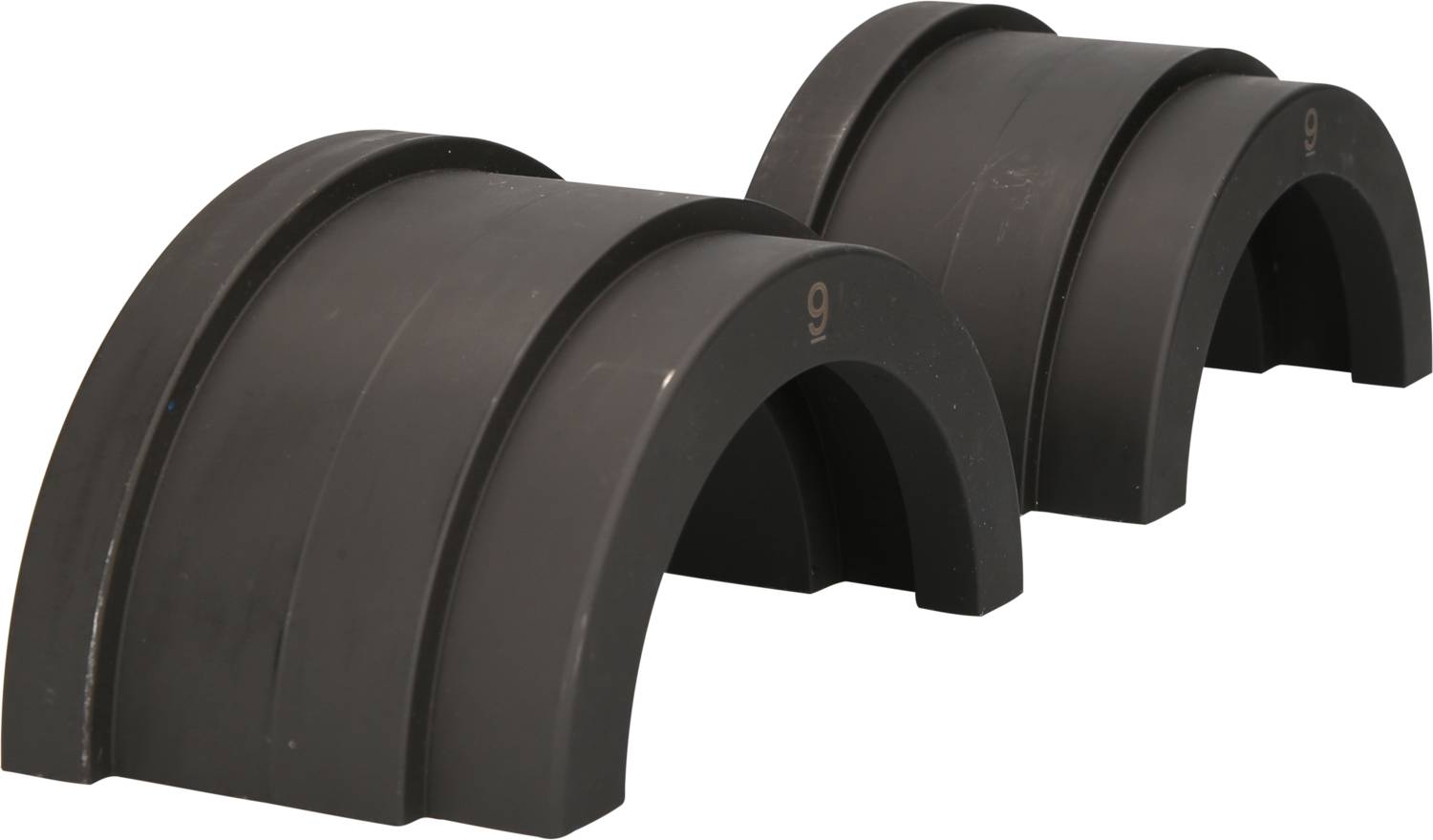 Two black, semi-circular plastic parts in different sizes. They are lying next to each other and each has engraved numbers.