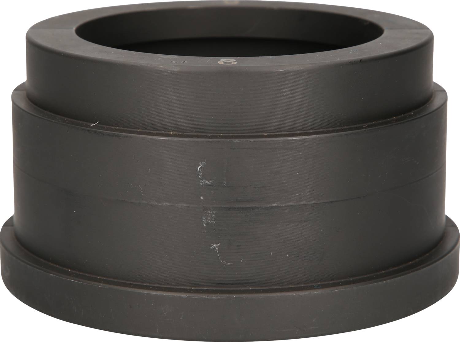 A black, cylindrical plastic object with multiple graduated levels.