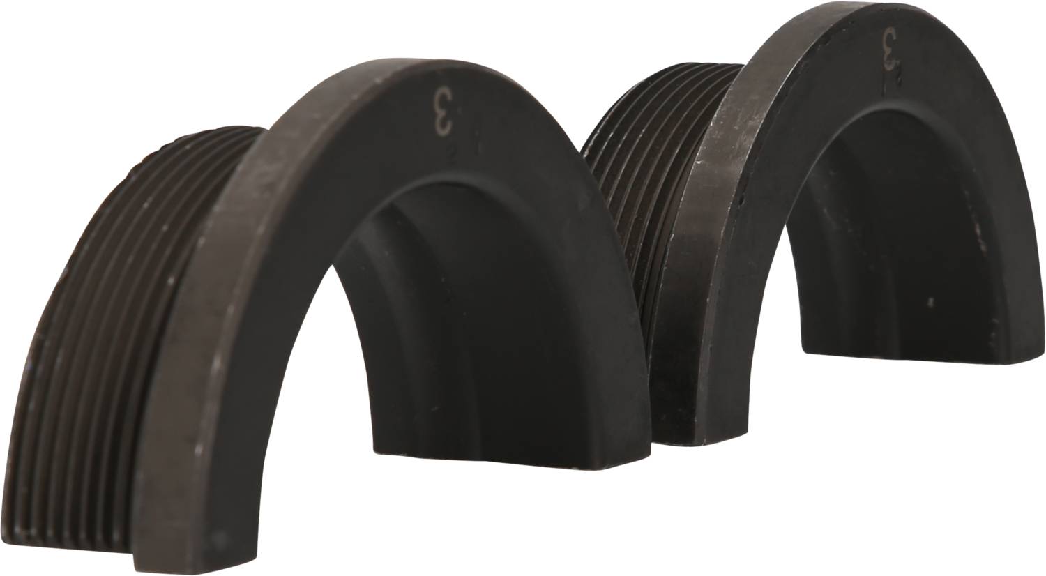 Two black, semi-circular objects with ribbed surfaces, placed side by side.