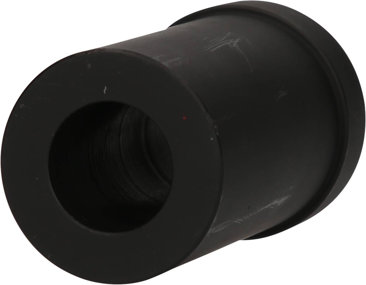 Black cylindrical object with a large opening, apparently a mechanical component.