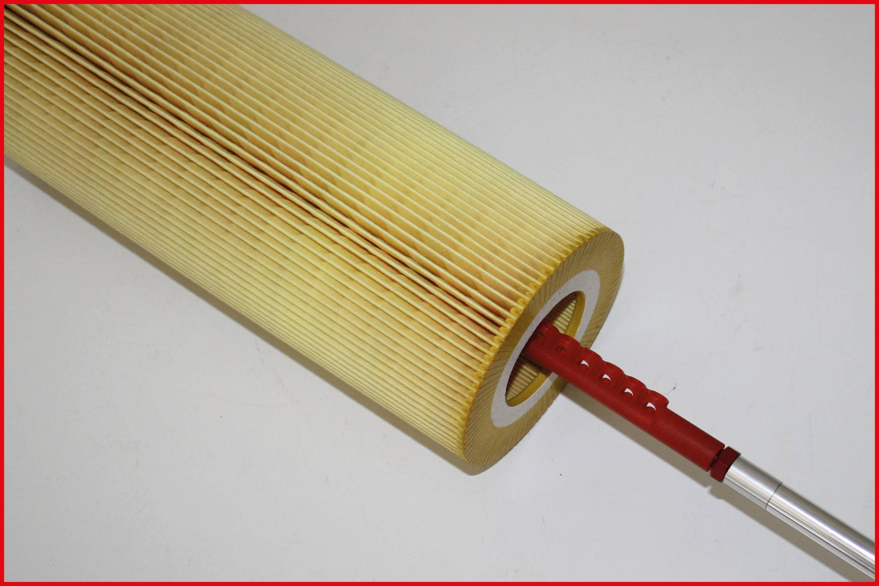 Yellow cylindrical filter with a red handle in the middle, indicating use for filtration systems or machines.