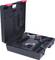 A black tool case containing a cordless drill and charger. The case is open, and the charger has a cable.