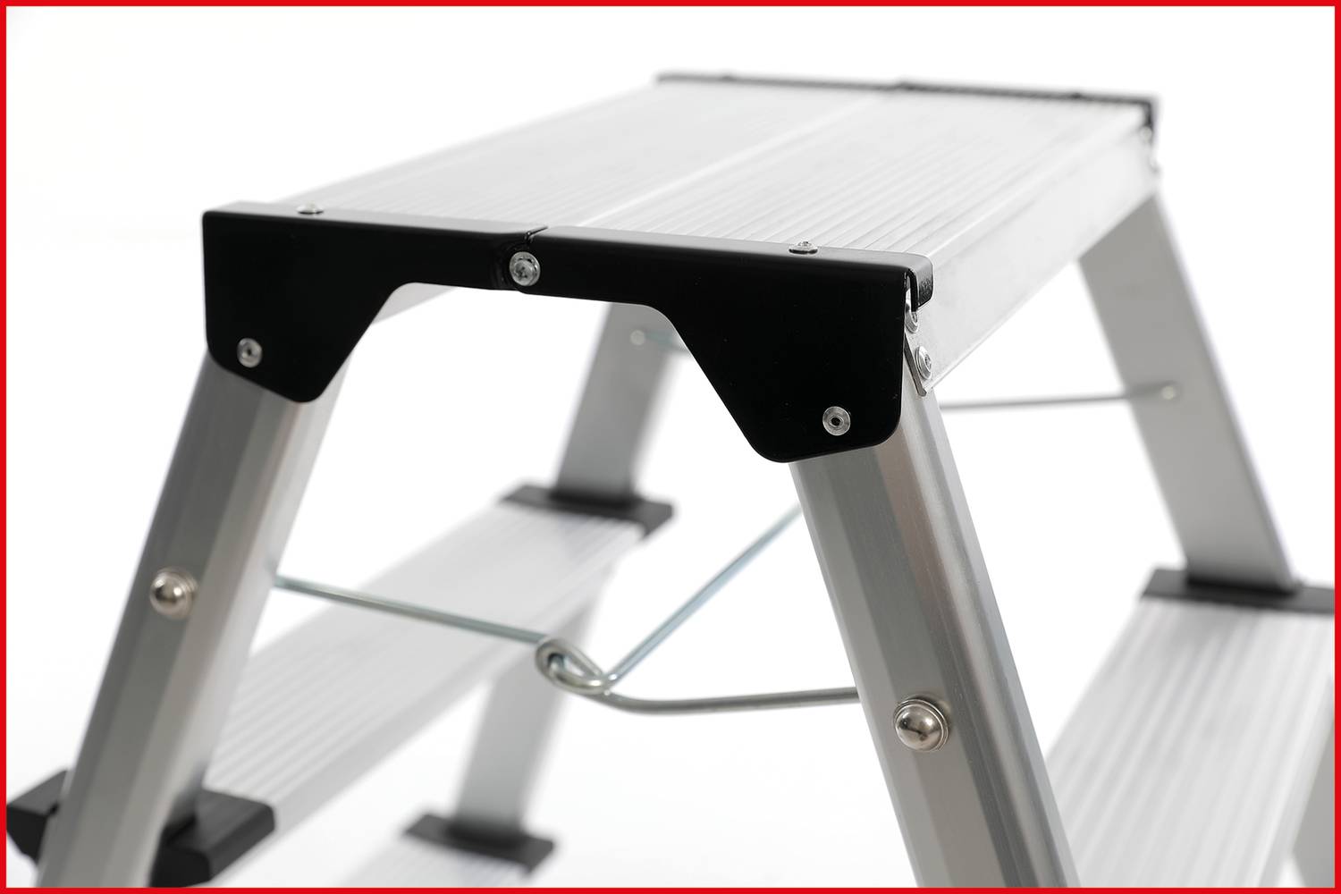 An aluminium ladder with two steps, partially visible. It has black protective end caps and is shown against a white background.