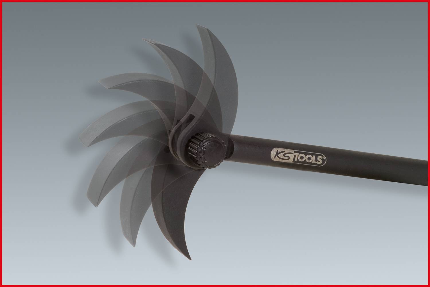 A shovel with a rotating head in motion. The tool has curved blades that enable effective soil cultivation.