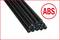 Black ABS plastic rods, stacked side by side. Next to the right, a red circle with the text 'ABS'.