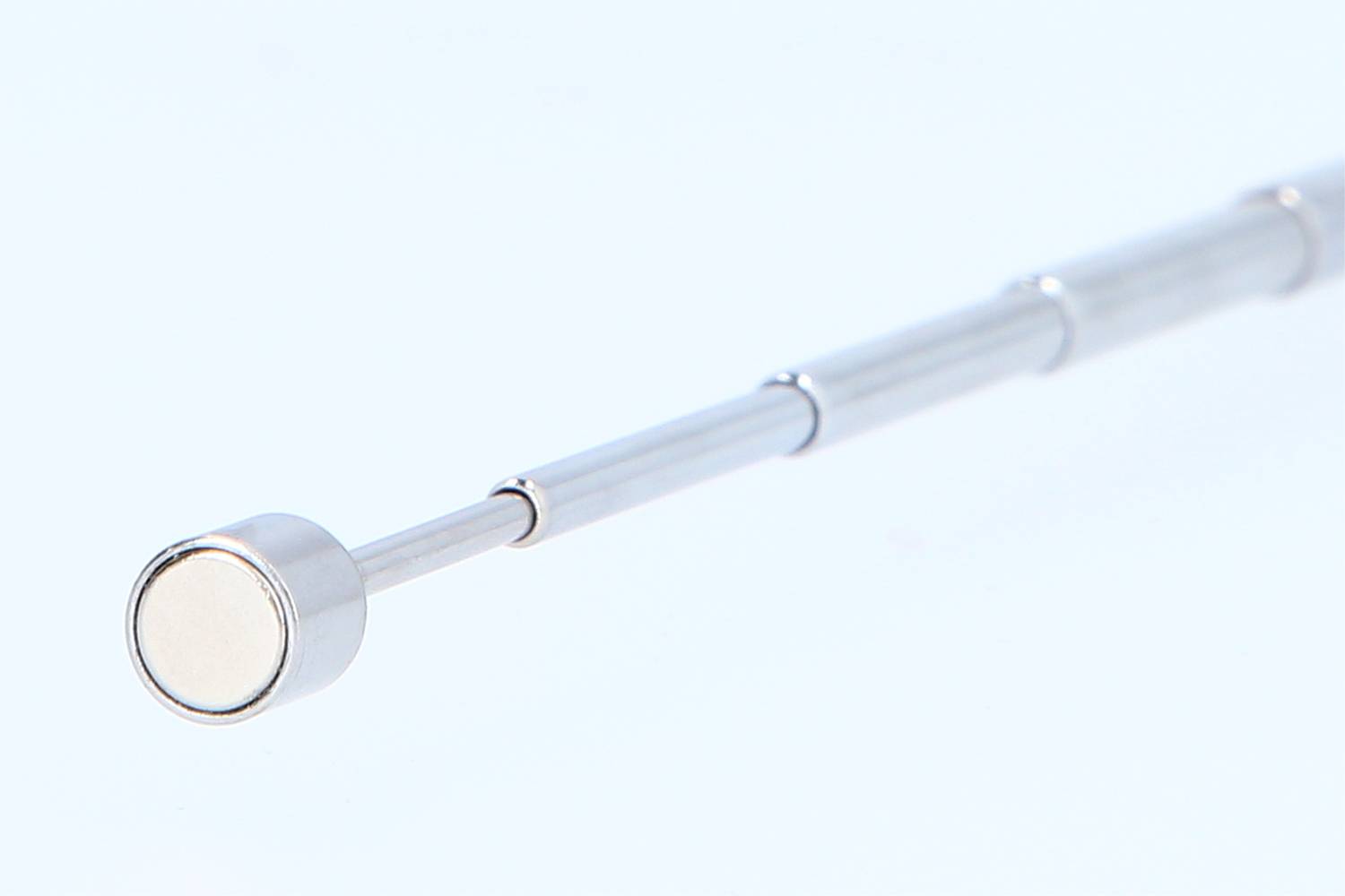 Telescopic Magnetic Rod, silver, with multiple segments. Primary purpose: to pick up metals or reach inaccessible areas.