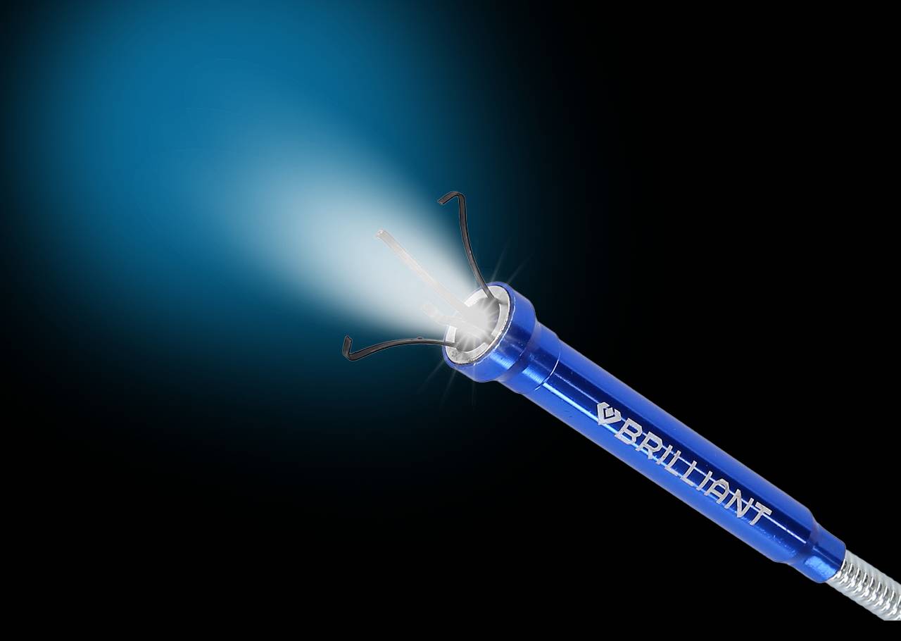 A blue, luminous repair pen with the inscription 'BRILLIANT' activates a precise light beam, depicted against a dark background.