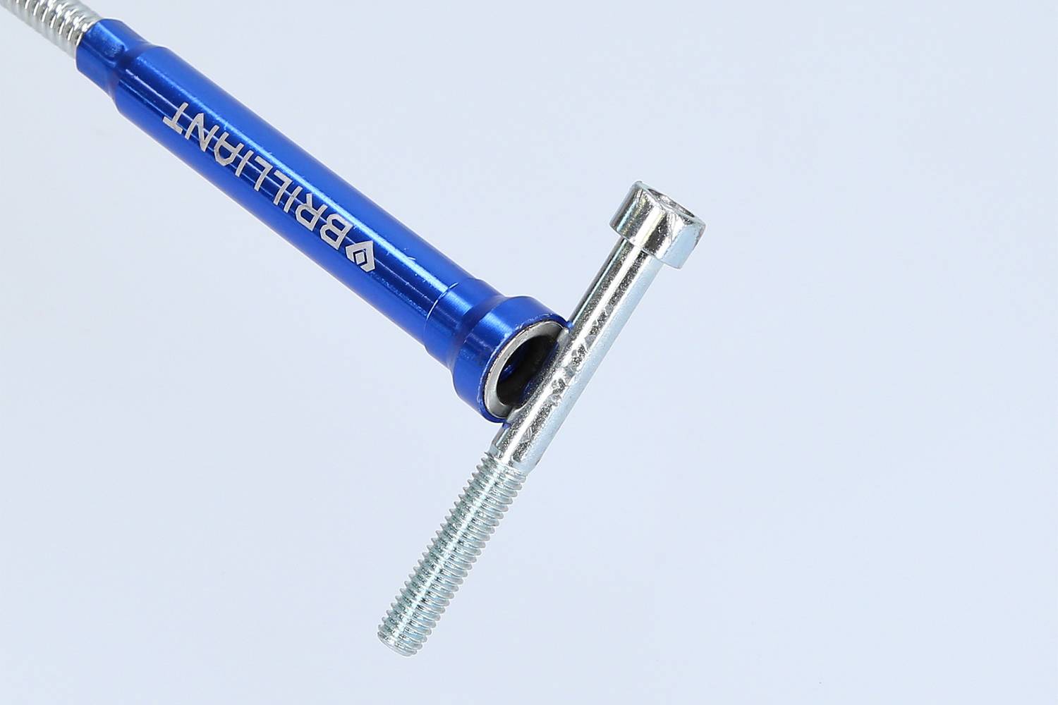 A blue bicycle valve adapter from 'BRILLIANT' next to a silver valve cap, on a light background.