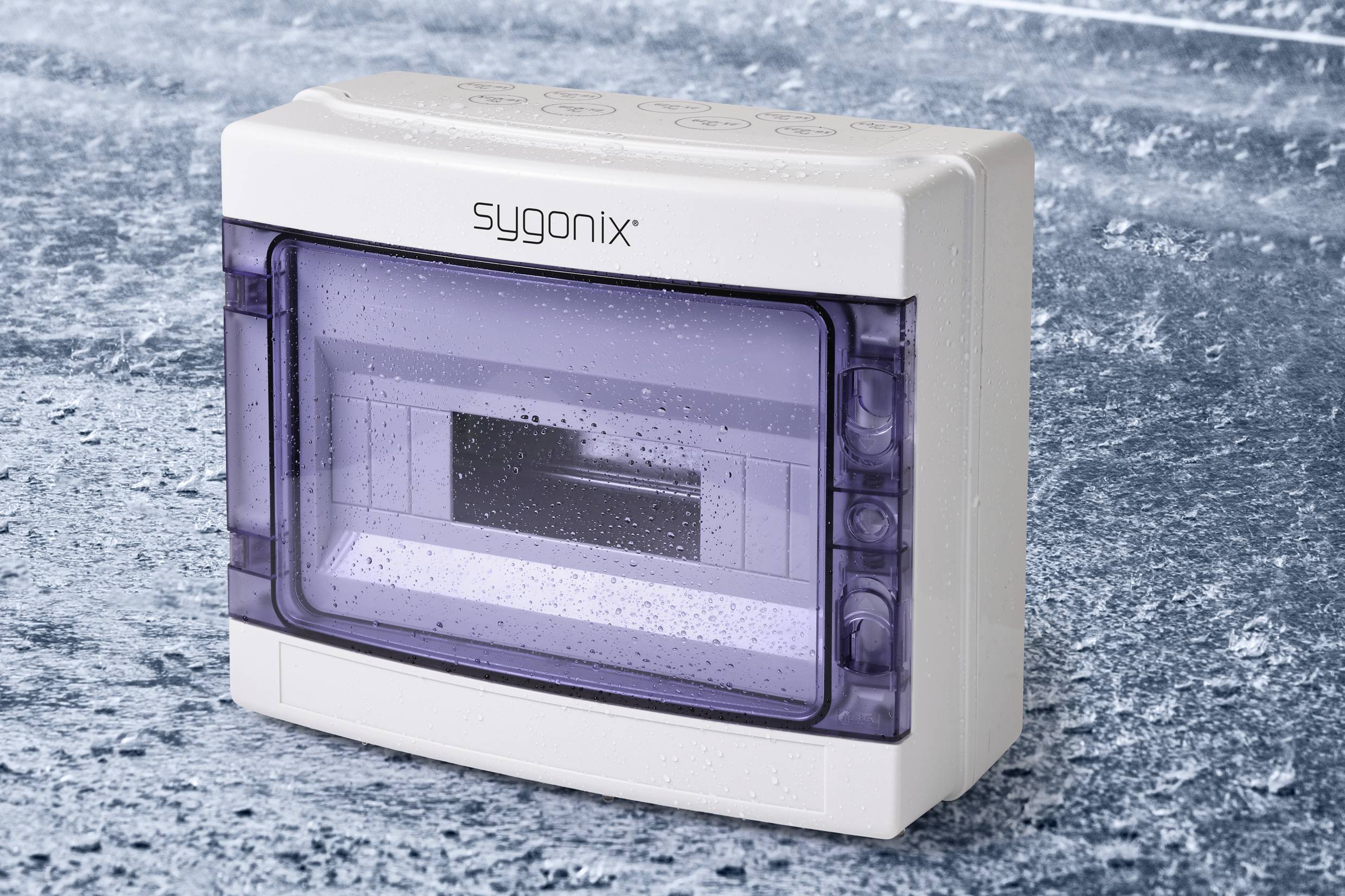White Sygnonix housing box with a transparent lilac lid, sitting on an ice-blue textured surface. Protective case for electronics.
