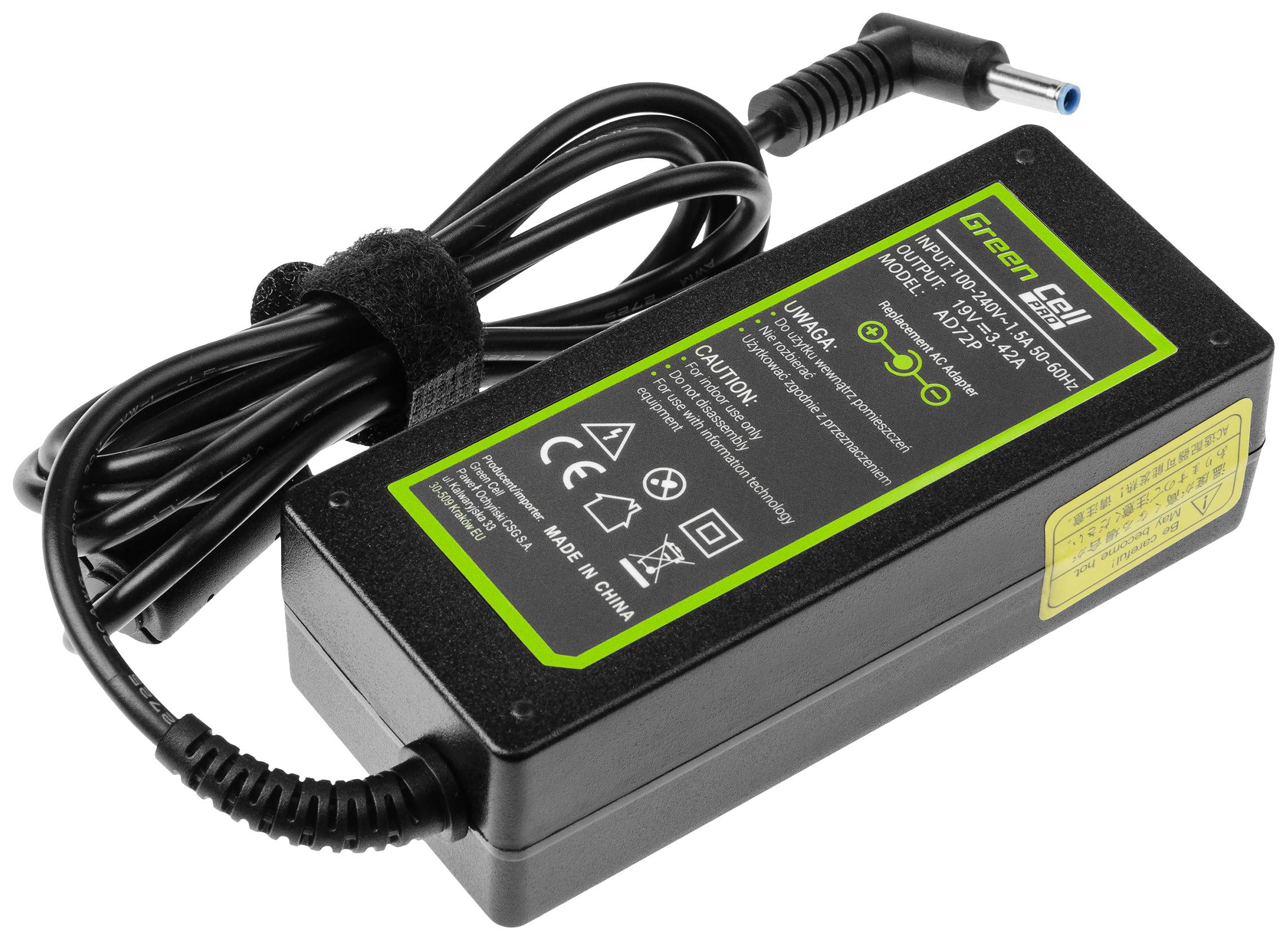 Laptop charger by Green Cell with mains plug, black cable, and green stickers displaying technical details and safety information.