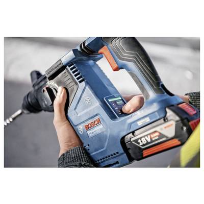 A person holds a blue Bosch Professional 18V drill, showing its cordless design and ergonomic grip, ready for use.
