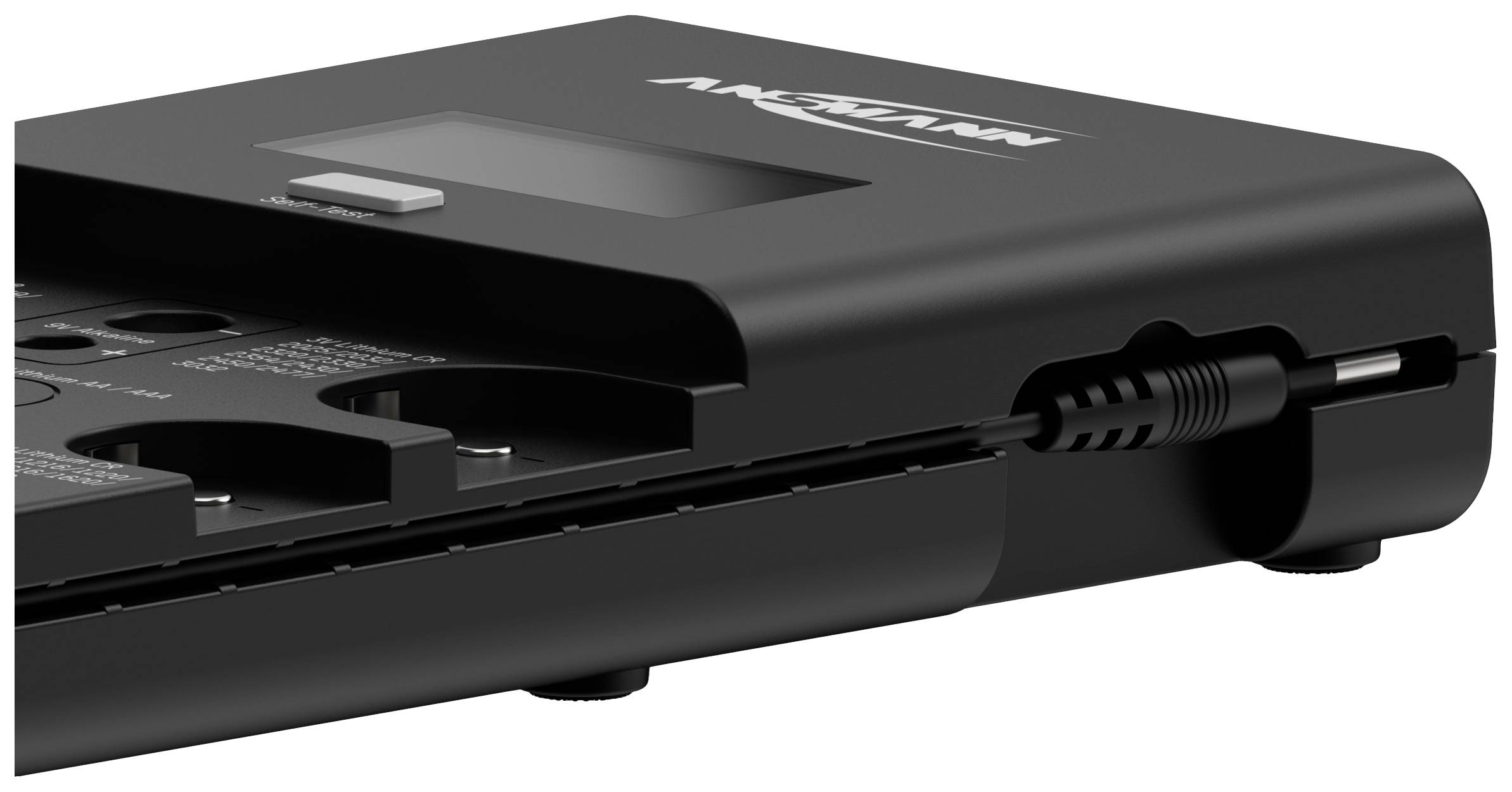 A black electronic device with a display, slots, and a power cable, likely a charger or adapter.