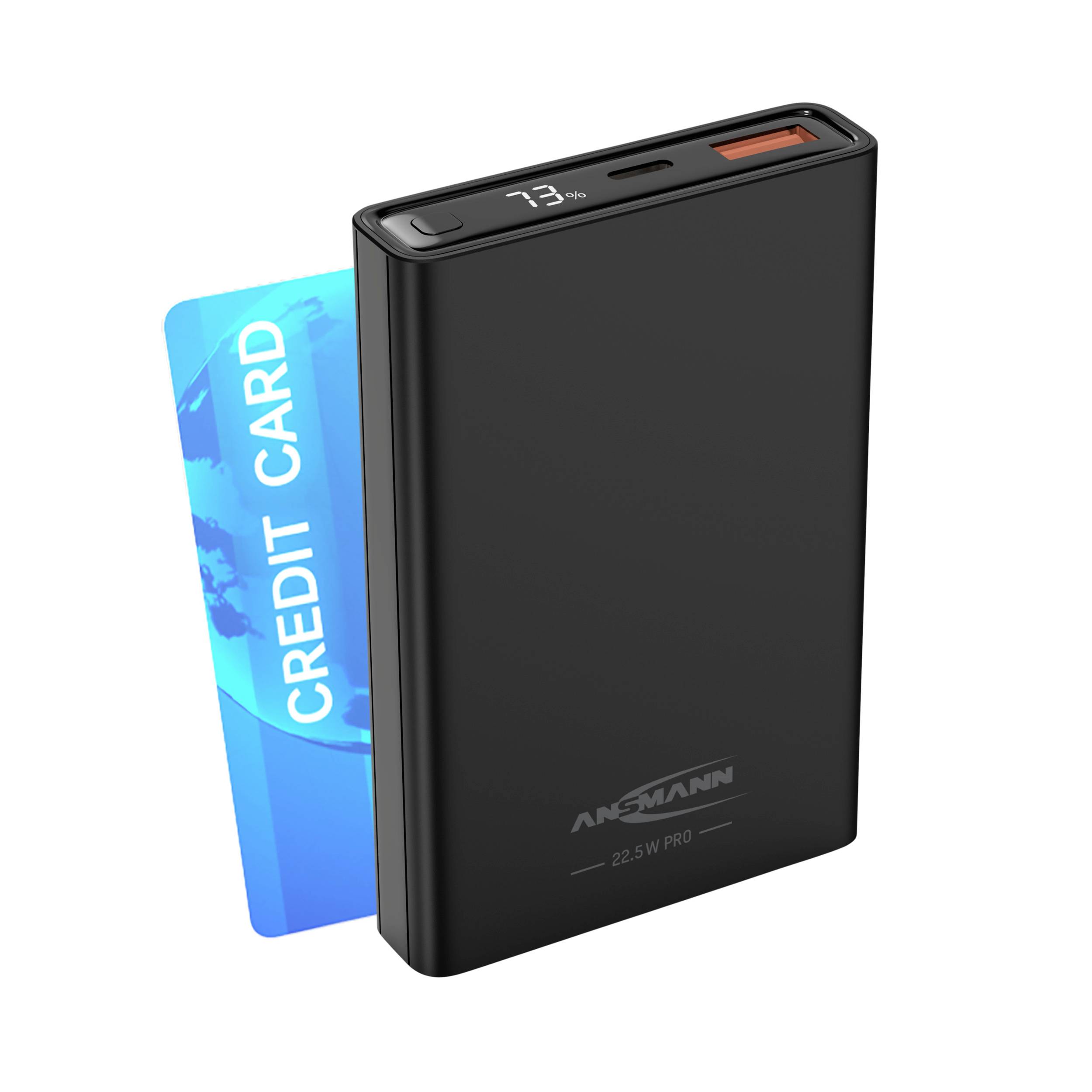 Black portable charger with LED display showing 73%, next to a blue credit card. Ansmann product, lightweight and compact.