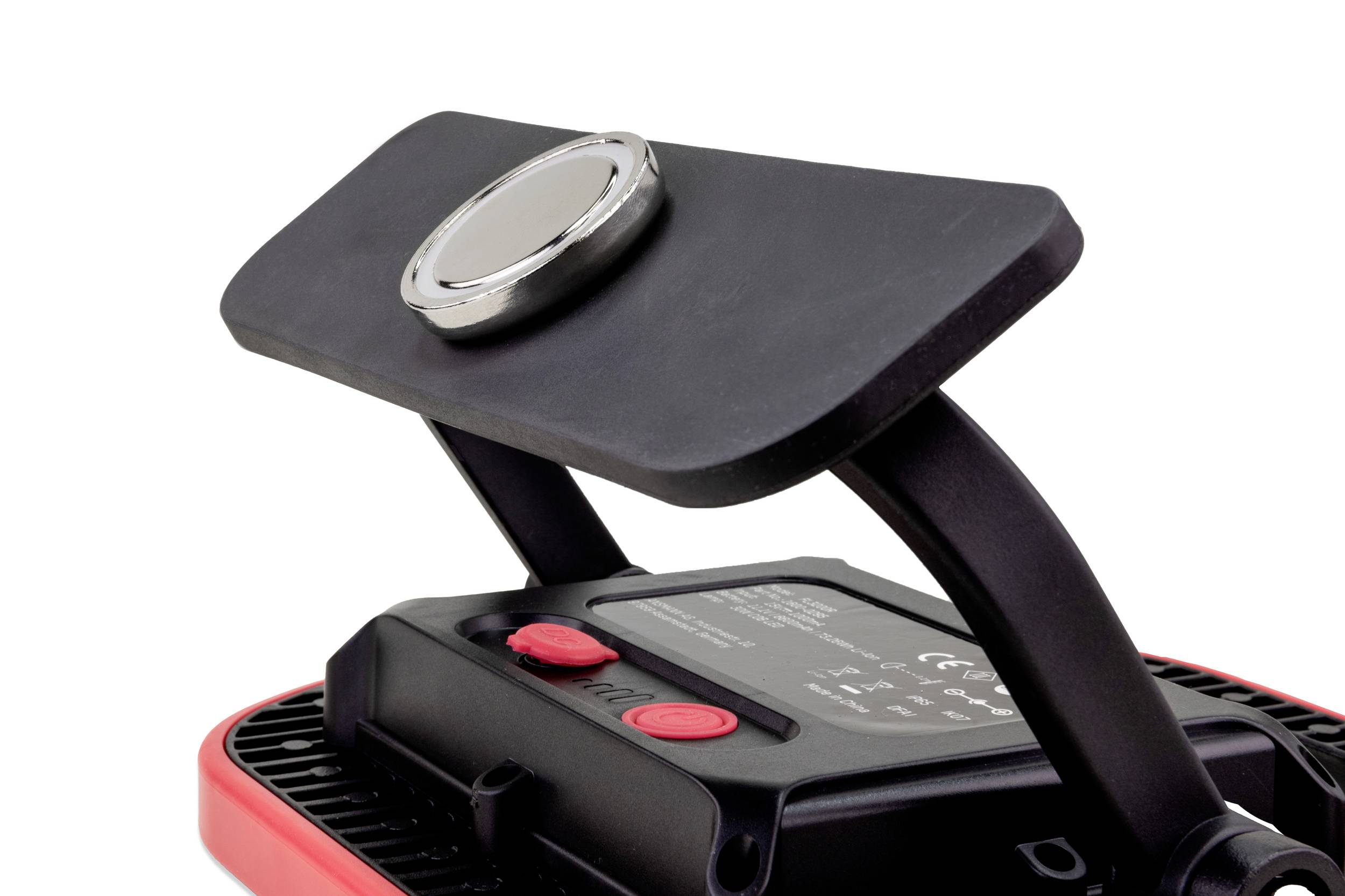 LED work light with a black housing and red trim. Two red buttons and an adjustable stand are visible.