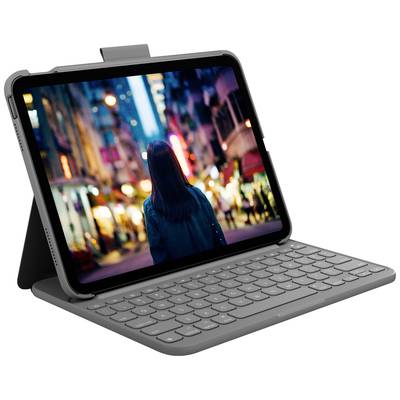 A tablet with a keyboard displays a nocturnal street scene photograph featuring a person from behind, surrounded by blurred city lights.