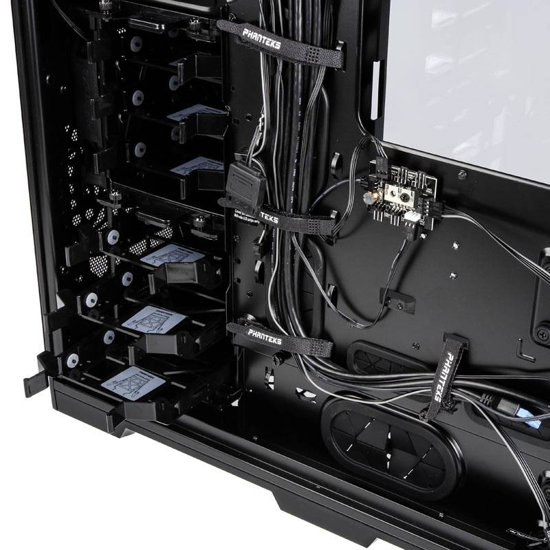 Interior view of a computer case with cable management; multiple hard drive bays and a motherboard are visible.