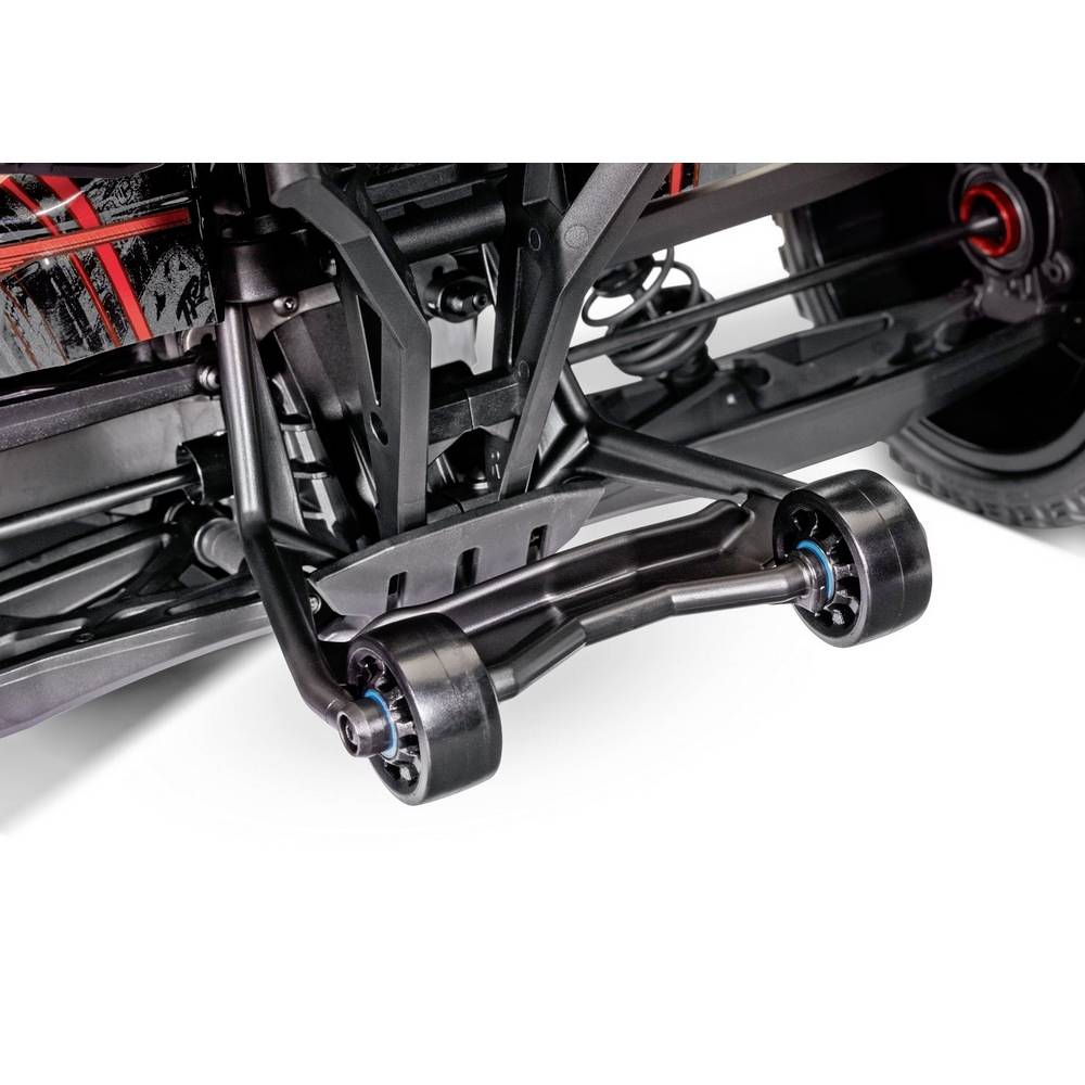 Close-up of a vehicle's suspension with visible springs and stabiliser bars, revealing technical details and structural components.