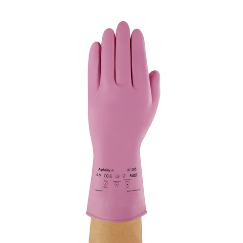 A hand is wearing a pink latex glove with safety markings.