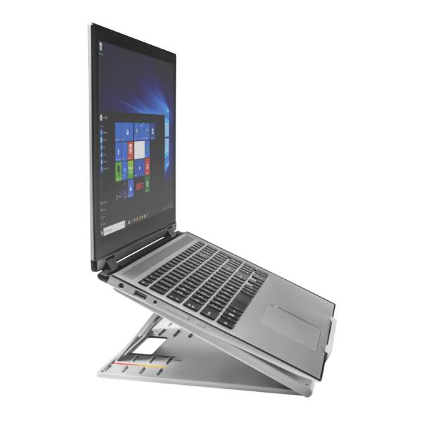 A laptop viewed from the side, placed on a stand that elevates the screen. The desktop displays Windows with multiple app icons.