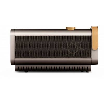 A rectangular, bronze-coloured speaker with a round volume control in the top right corner and a stylised sun motif on the side.