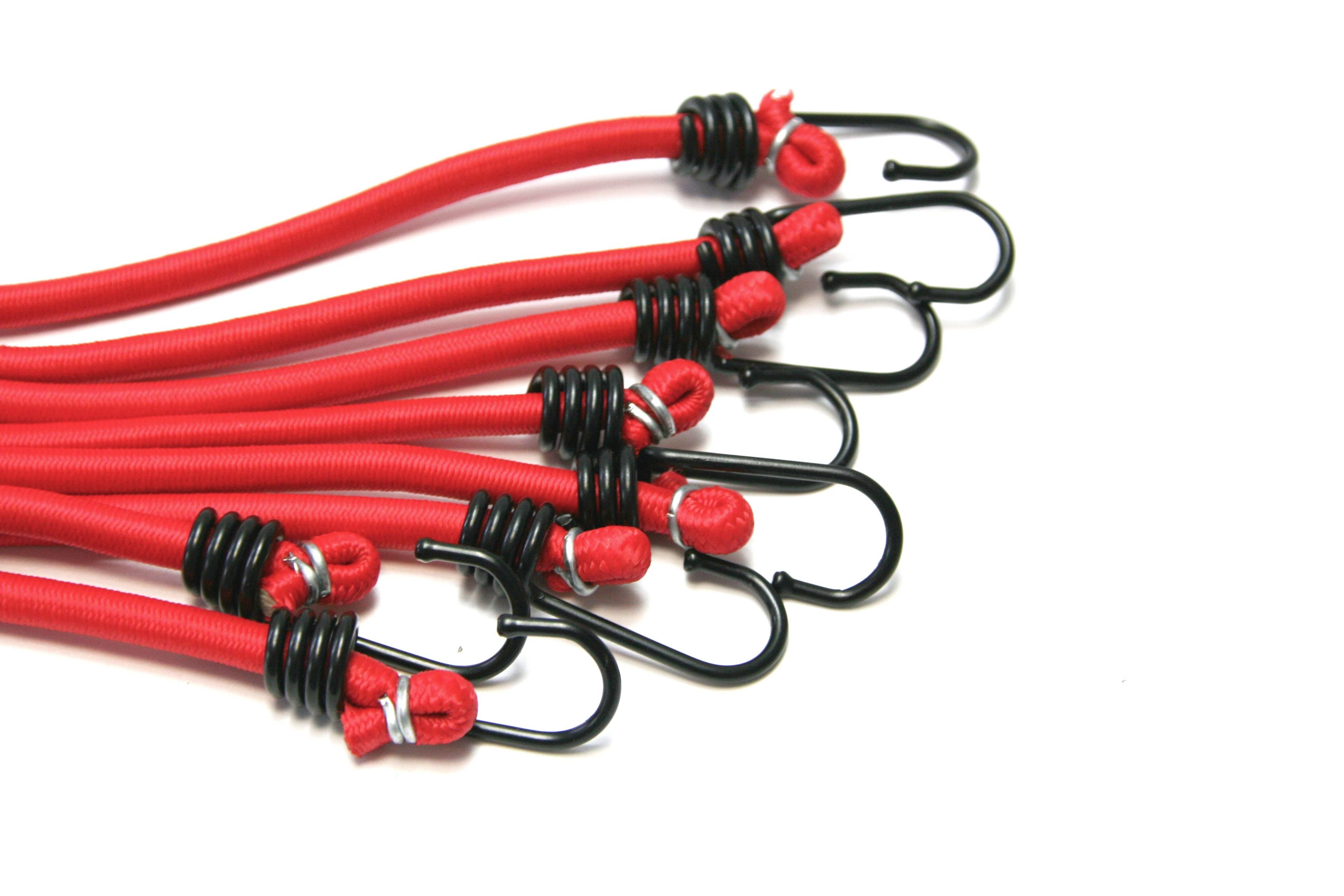 Red elastic straps with black hooks. Seven pieces lying side by side, ideal for securing items during transport.
