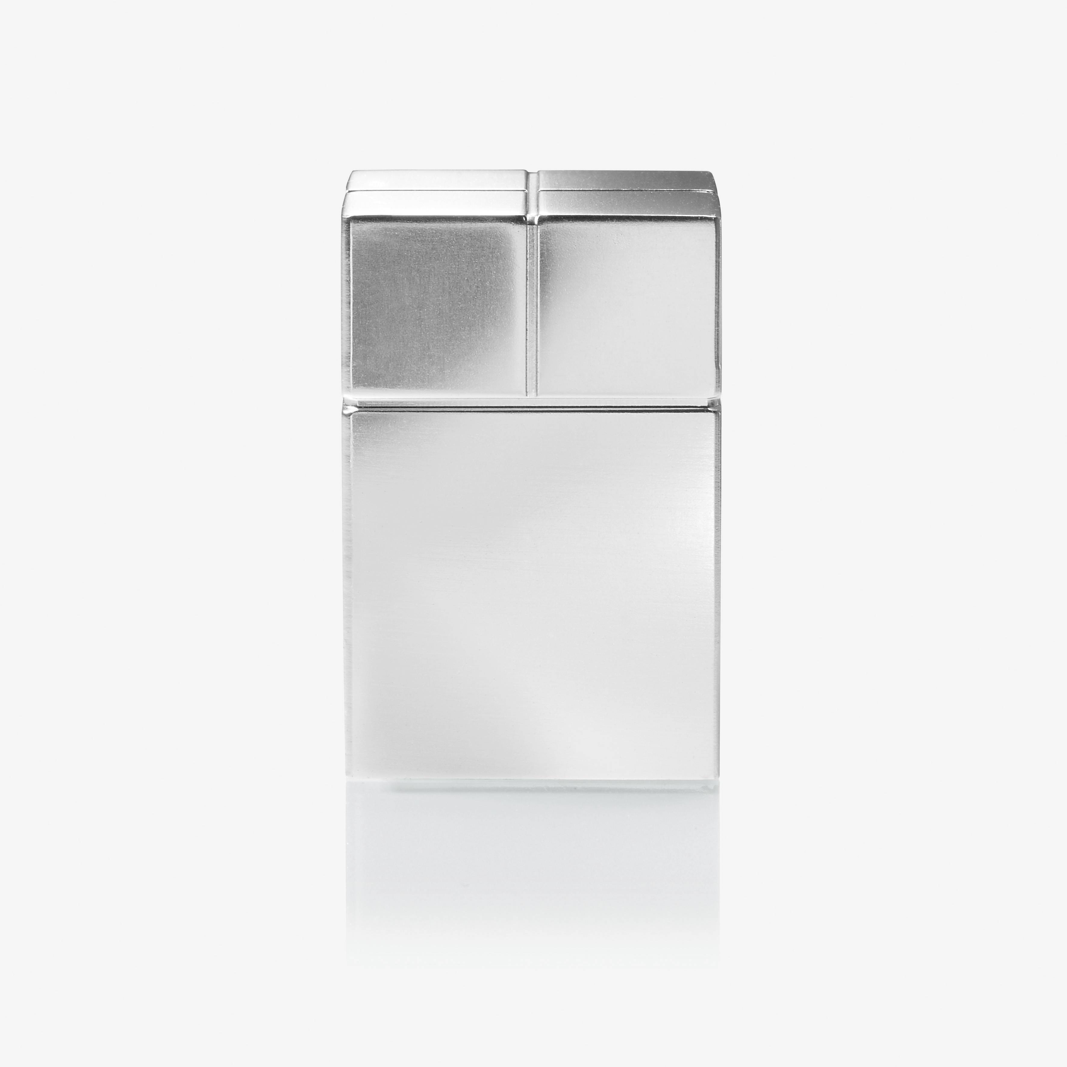 A silver, rectangular object, possibly a plain lidded container, against a neutral background.