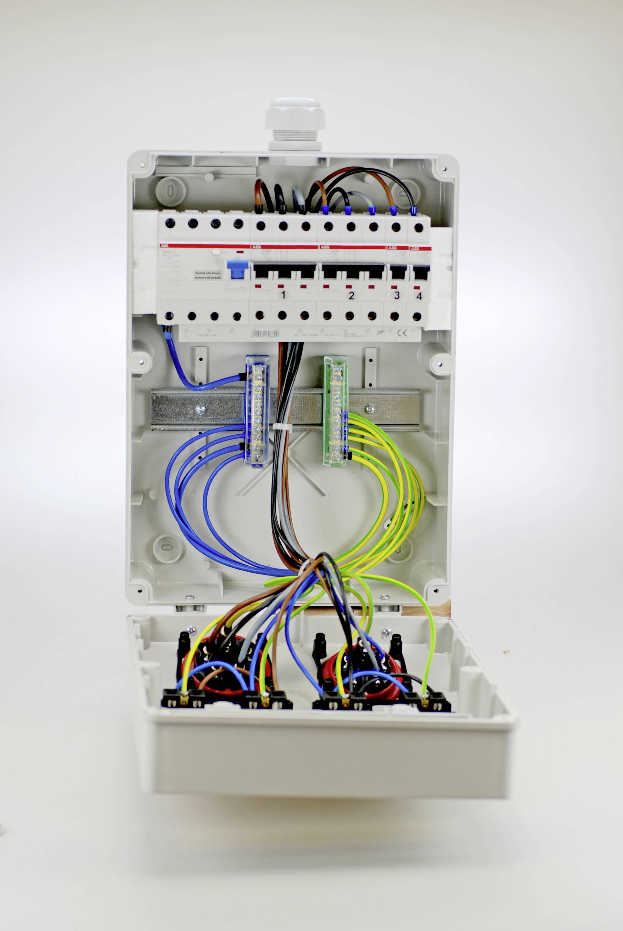 An open fuse box with visible cables and circuits. Various cables are colour-coded.