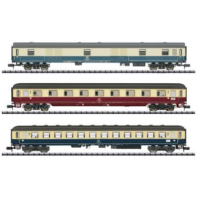 Three different model railway passenger carriages in varying colours and designs, positioned side by side on rails.
