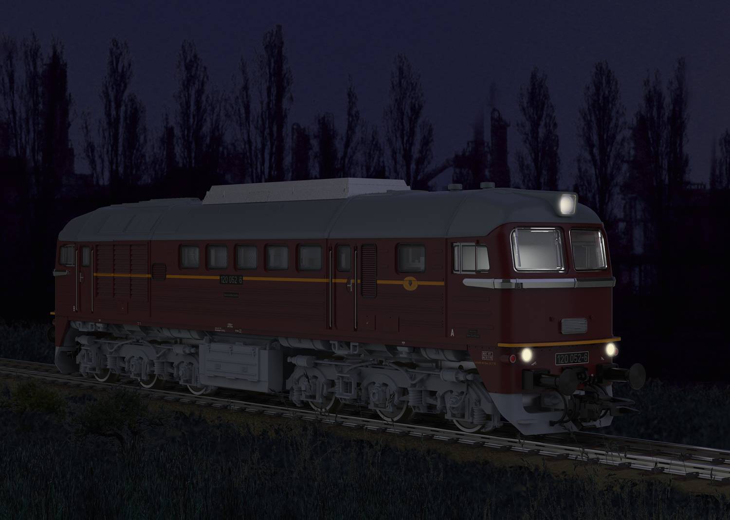 A red train travels at night along a track, surrounded by dark trees in the background. Its headlights illuminate the way.