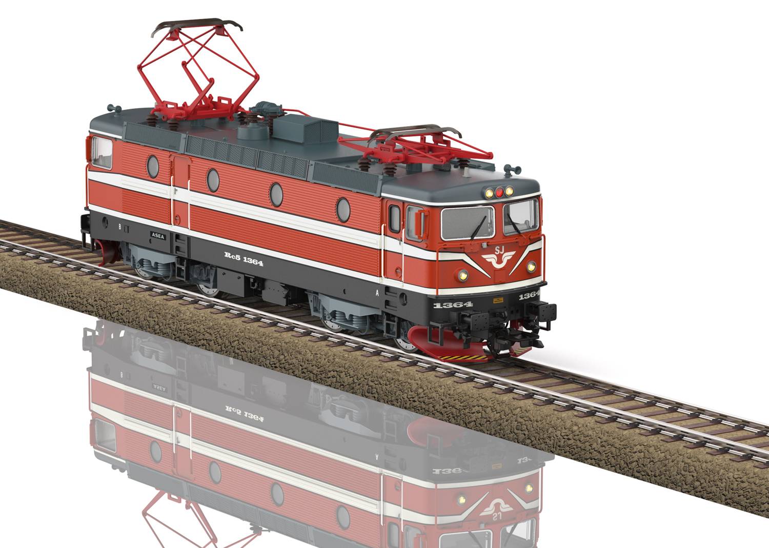 A red electric locomotive is travelling on a railway track. It has red details and is moving over a section of ballast.