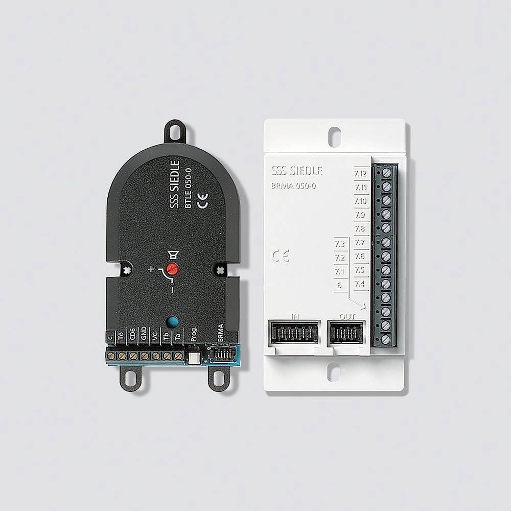 'Electronic module with black and white cover, multiple connection points and labels.'