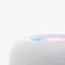 A round, white speaker with an illuminating light on its top surface. Design modern and minimalist.