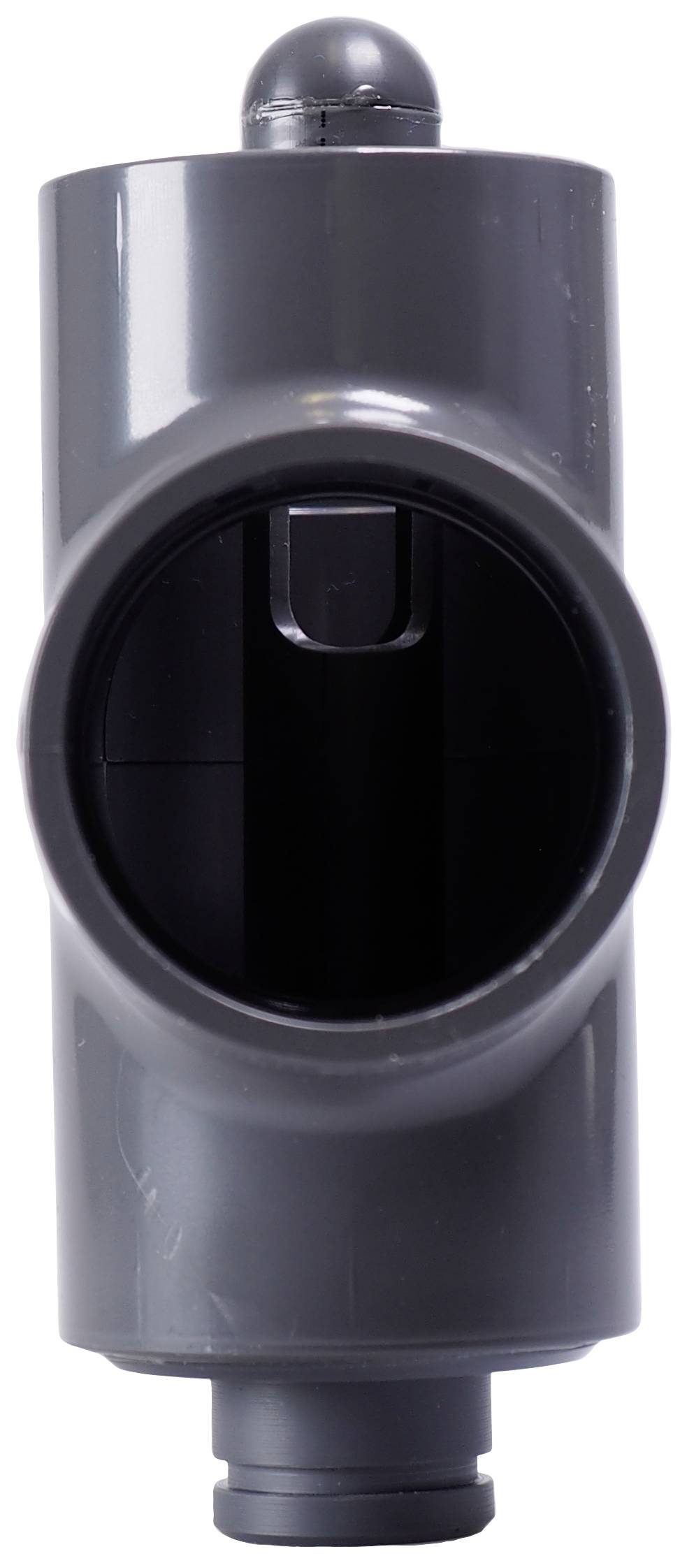 A grey plastic pipe with a lateral opening, possibly part of a ventilation system or an installation.