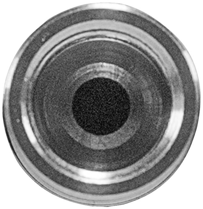 Black and white close-up photograph of a round metal opening, likely the tip of a pen or technical device.